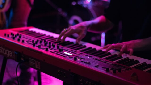 person playing electronic keyboard